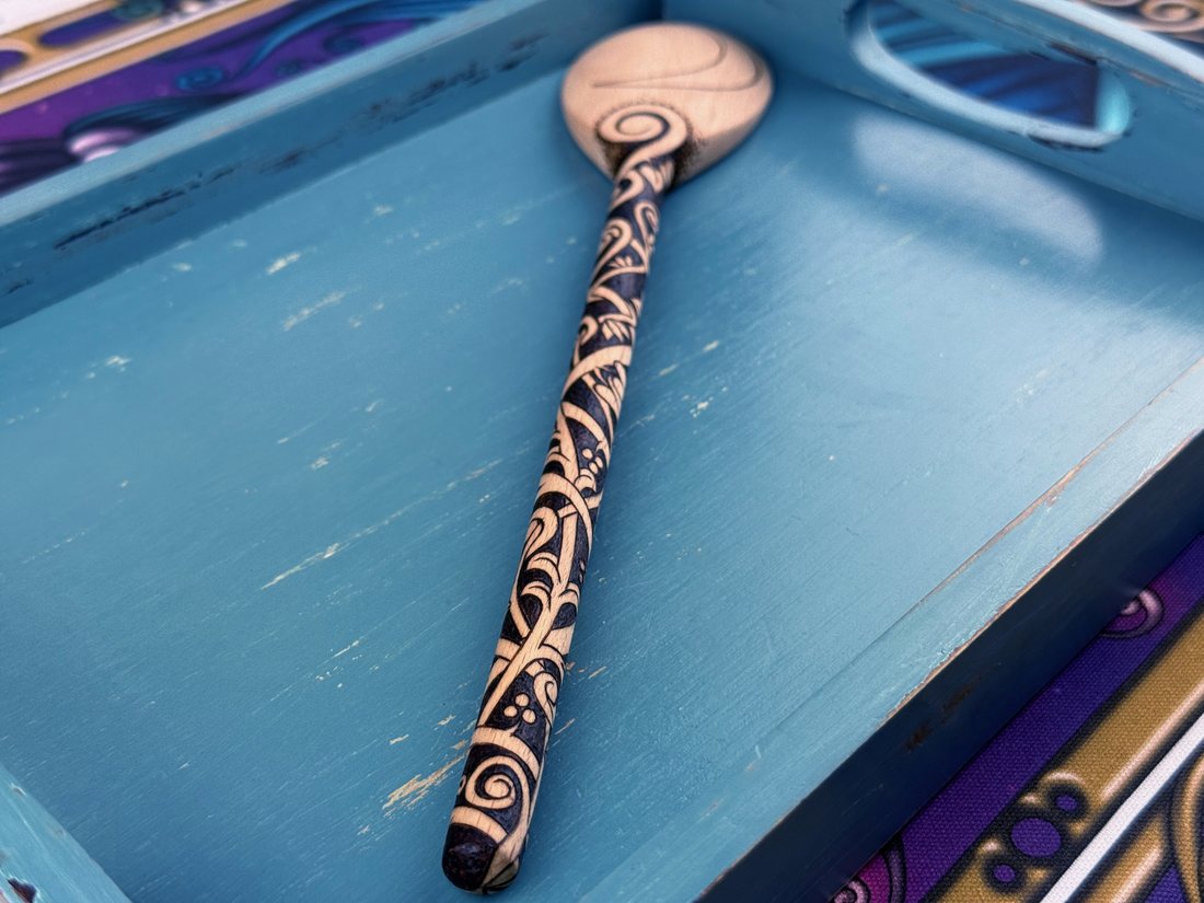 Finished moon spoon resting in a painted blue tray